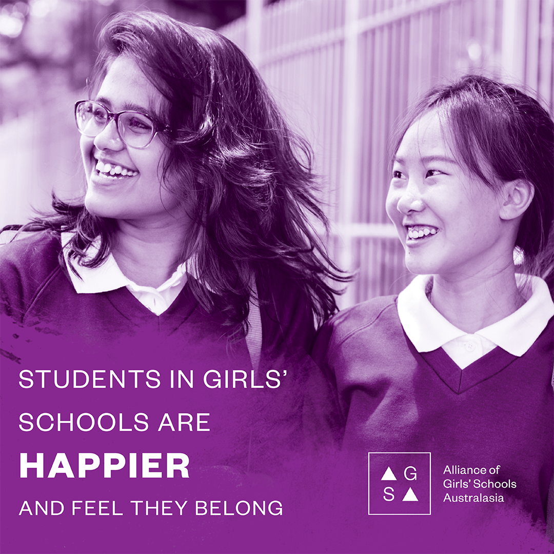 Two students smiling and walking together with text stating girls’ school students are happier and feel they belong
